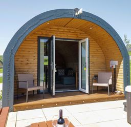 A pod with chairs and a table in an outdoor area at Cherry in Ulverston