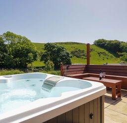A hot tub and seating area with a view at Cherry in Ulverston