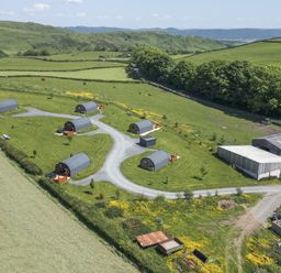 An outdoor area with cabins and fields at Cherry Ulverston