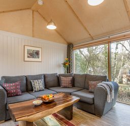 A living room with a sofa and coffee table at Lodge 17 in Corfe Castle