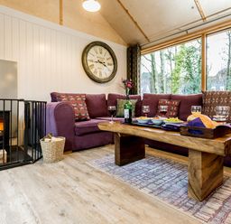 A living room with a coffee table and a fireplace at Lodge 19 in Corfe Castle