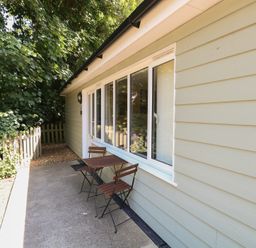 An outdoor area with a table and chairs at 15 The Dell Mundesley