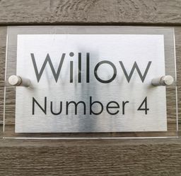 A house name sign reading Willow Number 4 mounted on a wooden wall at Willow Lodge in Winthorpe near Newark-On-Trent