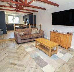 A living room with a sofa and coffee table at Mallard Cottage in Penrith