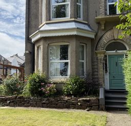 A house entrance with a green door and garden at The Furness Haven in Barrow-In-Furness
