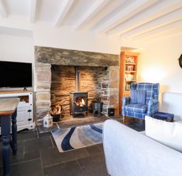 A living room with a fireplace and television at Ael Y Bryn Ffestiniog