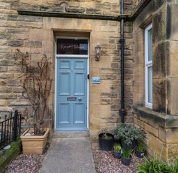An entrance with a blue front door at Rose House in Alnmouth