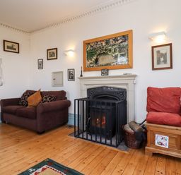 A living room with a fireplace sofa and cushions at Wick Court Farm Arlingham near Frampton On Severn