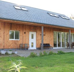 A house with patio furniture and garden at Narracott Down South Molton