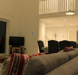 A living room with a sofa and television at Narracott Down South Molton