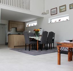 A dining room with a table and chairs at Narracott Down in South Molton