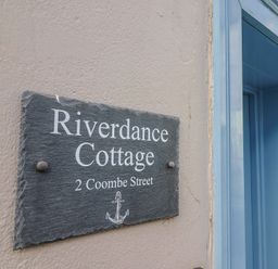 A plaque with Riverdance Cottage name at Riverdance Cottage in Lyme Regis