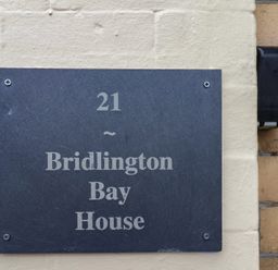 A sign displaying the address of Bridlington Bay House at Bridlington