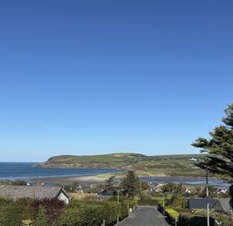 A view of the ocean and houses from a hill at Bryn Alaw in Newport, Pembrokeshire