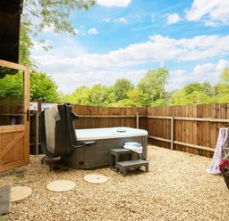 A garden with a hot tub and seating area at Hazel in Blandford Forum