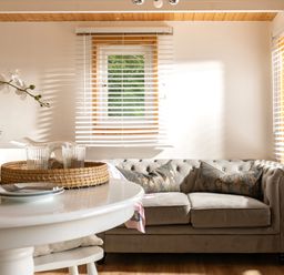 A living room with a sofa and table at Hazel in Blandford Forum