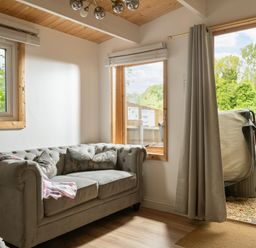 A snug with a sofa and hot tub visible at Hazel in Blandford Forum