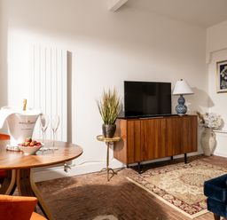 A living room with a television and a round table at Stable in Blandford Forum