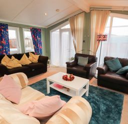 A living room with sofas and a coffee table at Rosie's Zen Den in High Hesket near Armathwaite