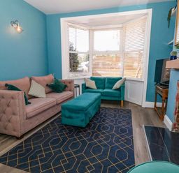 A living room with a sofa and footstool at The Old Post Office in Weymouth