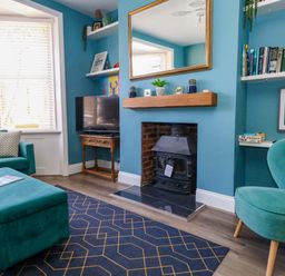 A living room with a television and fireplace at The Old Post Office in Weymouth