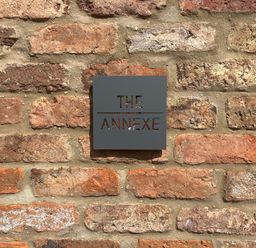 A metal sign with the text The Annexe on a brick wall at The Annexe in Bridlington