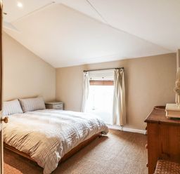 A bedroom with a bed and side table at 5 Prospect Place Woodbridge