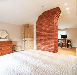 A bedroom with a bed, dresser, desk and chair at 5 Prospect Place in Woodbridge