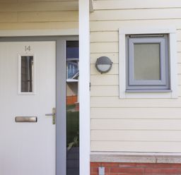 A front door with a mail slot and a small window at The Beach House (Beadnell) Beadnell