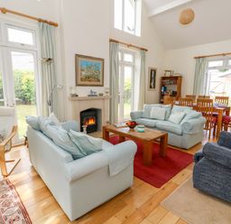 A living room with a coffee table and sofas at 1 Fernhill Avenue Weymouth