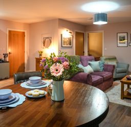 A living room with a table and chairs and a couch at Ystrad Wen near Newbridge-On-Wye
