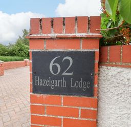 A house sign with the number 62 at Hazelgarth Lodge in Hunmanby