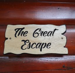 A wooden sign with the text The Great Escape on a wooden wall at The Great Escape in Kenwick near Louth