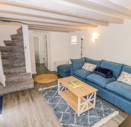 A living room with a sofa and coffee table at The Cottage in Ettington