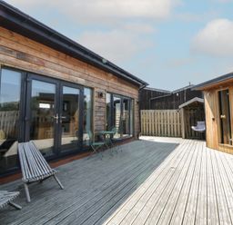 An outdoor area with wooden decking and furniture at Tin Shed Nantmel near Rhayader