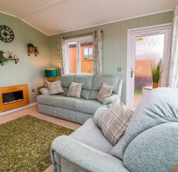 A living room with a sofa and armchair at Daffodil Lodge Mullacott near Ilfracombe