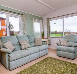 A snug with sofa and armchairs at Daffodil Lodge Mullacott near Ilfracombe