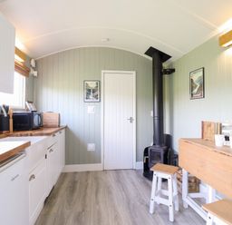 A kitchen with a sink and stove at Cuckoo at Wild Valley Huts Llanrhaeadr-Ym-Mochnant