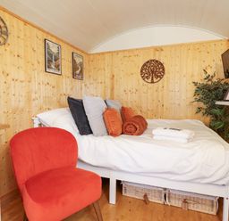 A bedroom with a bed and decor at Red Kite at Wild Valley Huts Llanrhaeadr-Ym-Mochnant