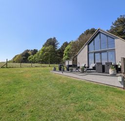 A house with a deck and seating area at Polly's Annexe Levington
