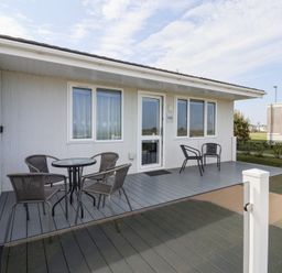 An outdoor patio with a table and chairs at Bonny Bay in Wilsthorpe near Bridlington