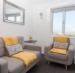 A living room with a sofa and armchair at Bonny Bay in Wilsthorpe near Bridlington