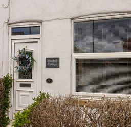 A door and window of Bluebell Cottage in Brayton