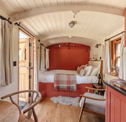A bedroom with a bed and side table at Spindleberry Hut in Piddletrenthide
