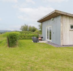A house with grass and shrubs at The Tinystore in Bodmin