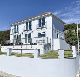 A house with balconies and a garden at Looe Island View in Downderry