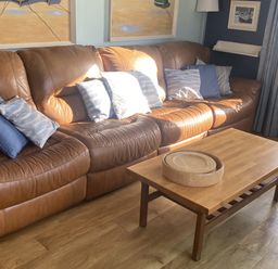 A living room with a sofa and coffee table at Seaspray in St Bees