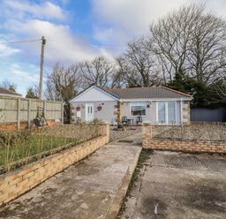 A house with a pathway and fencing at Old Colliery Cottage Shilbottle