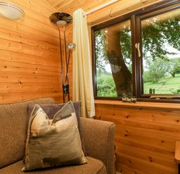 A sitting room with a sofa and window at Derwent Lodge in Keswick