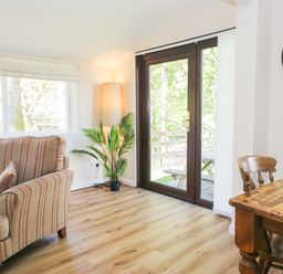 A living room with a sofa and dining table at Dogwood Timber Lodge in Keswick
